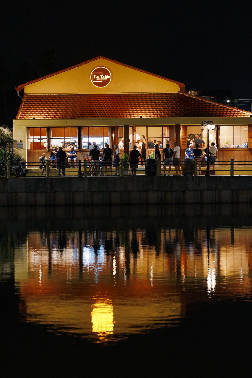La Table restaurant exterior at night with river reflections
