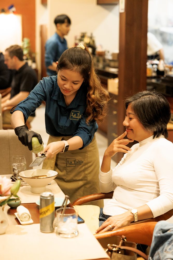 Staff serving guests with a smile at La Table